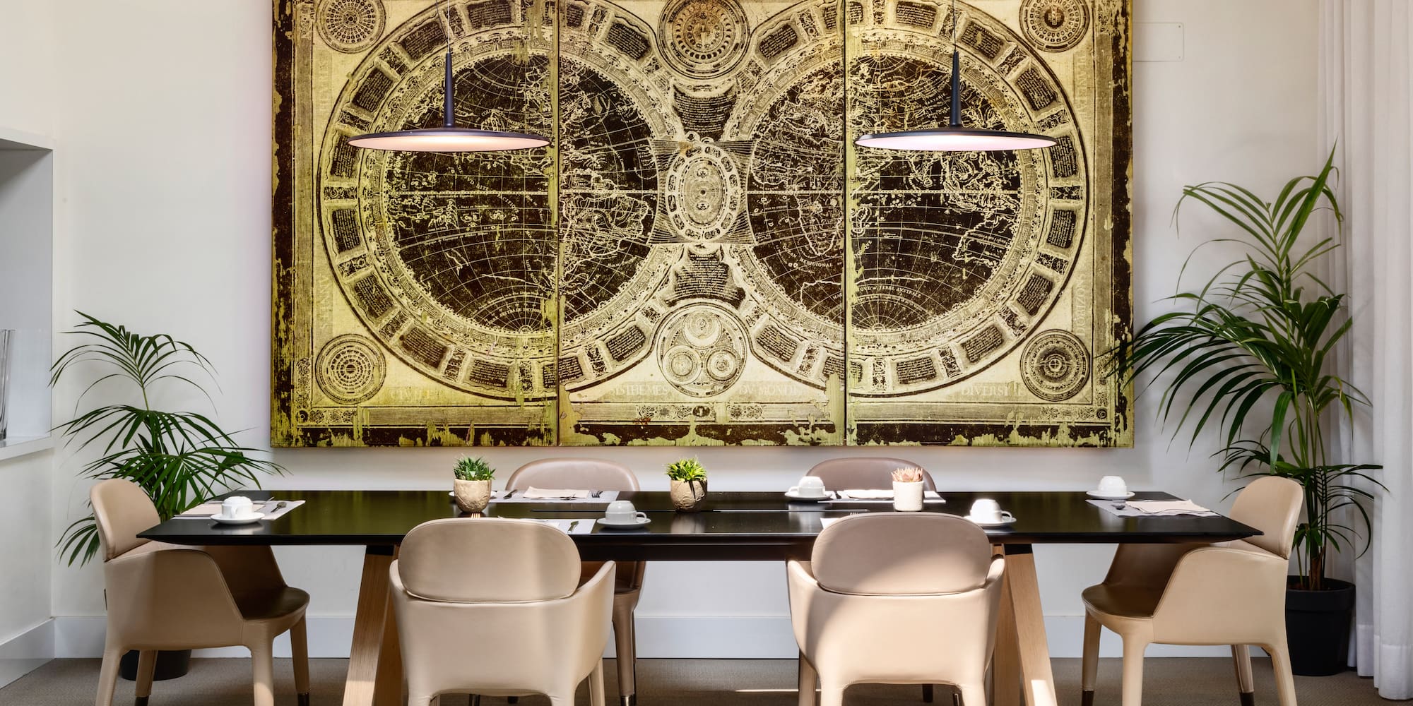 a table with chairs and a large painting on the wall