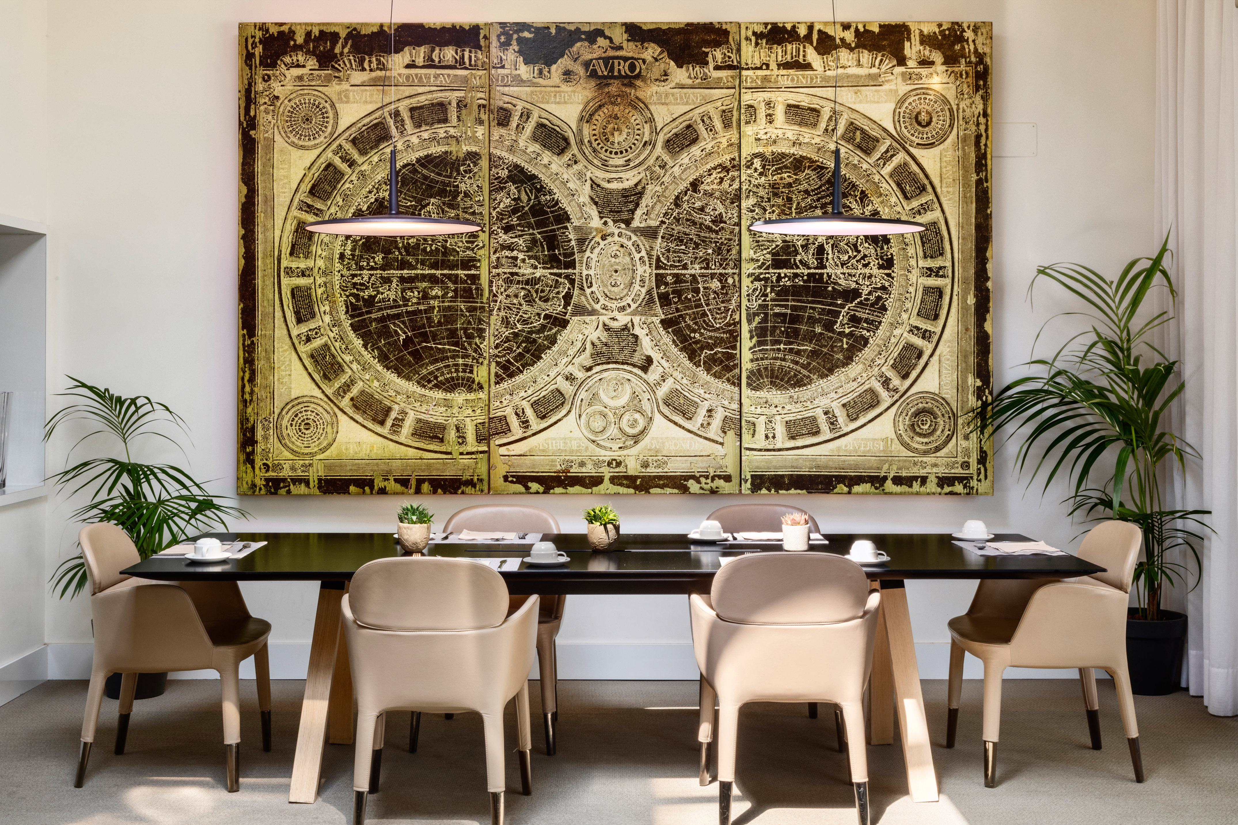 a table with chairs and a large painting on the wall