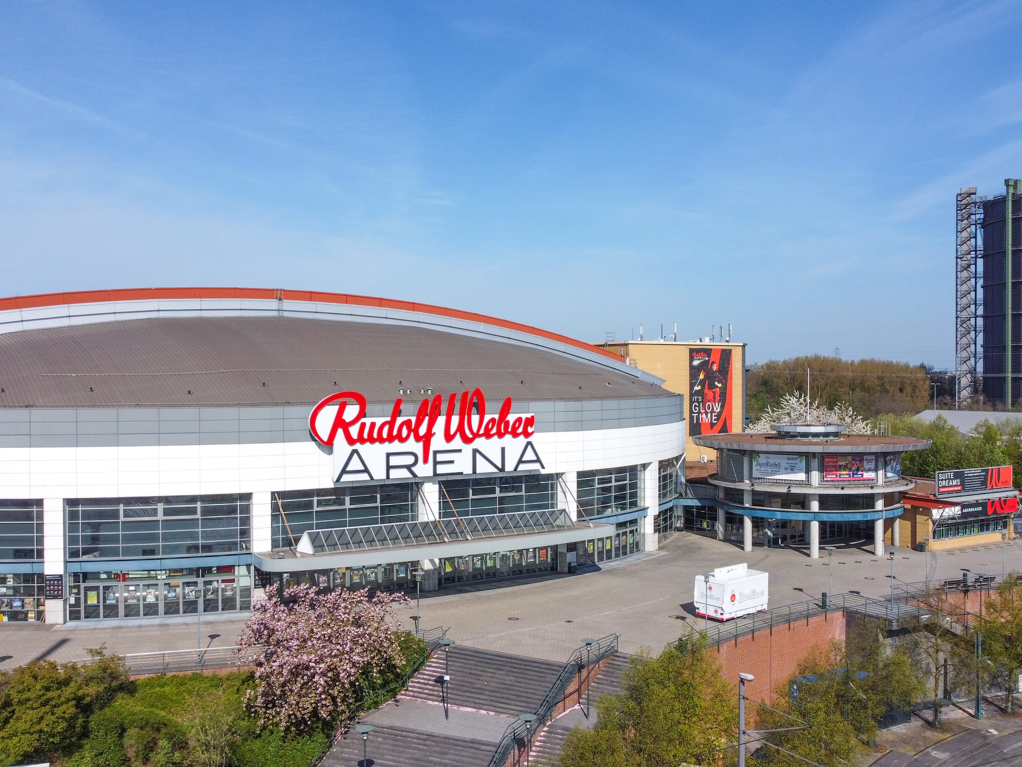 Rudolf Weber Arena with red logo, glass entrance, and gasholder.
