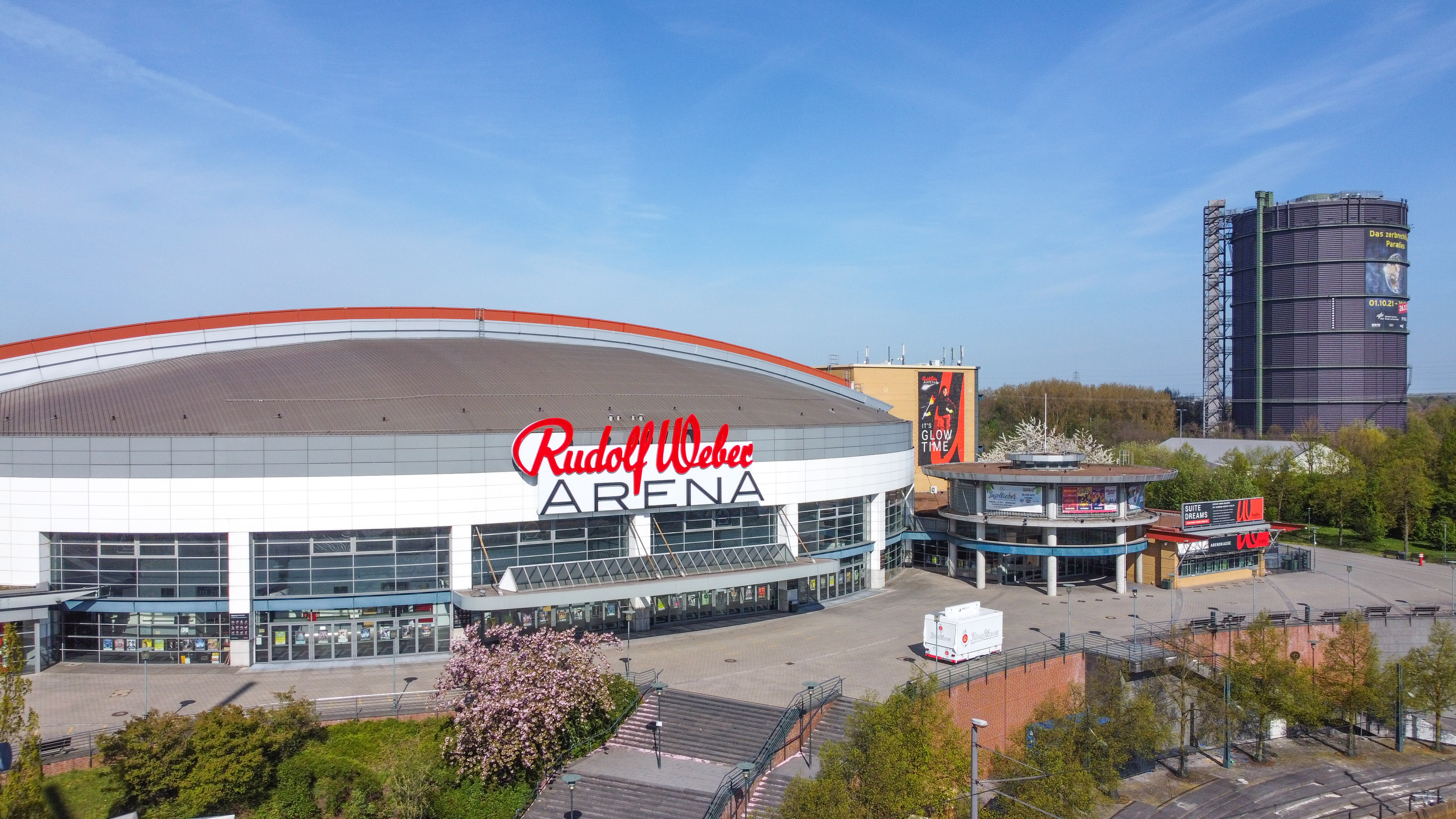 Rudolf Weber Arena with red logo, glass entrance, and gasholder.