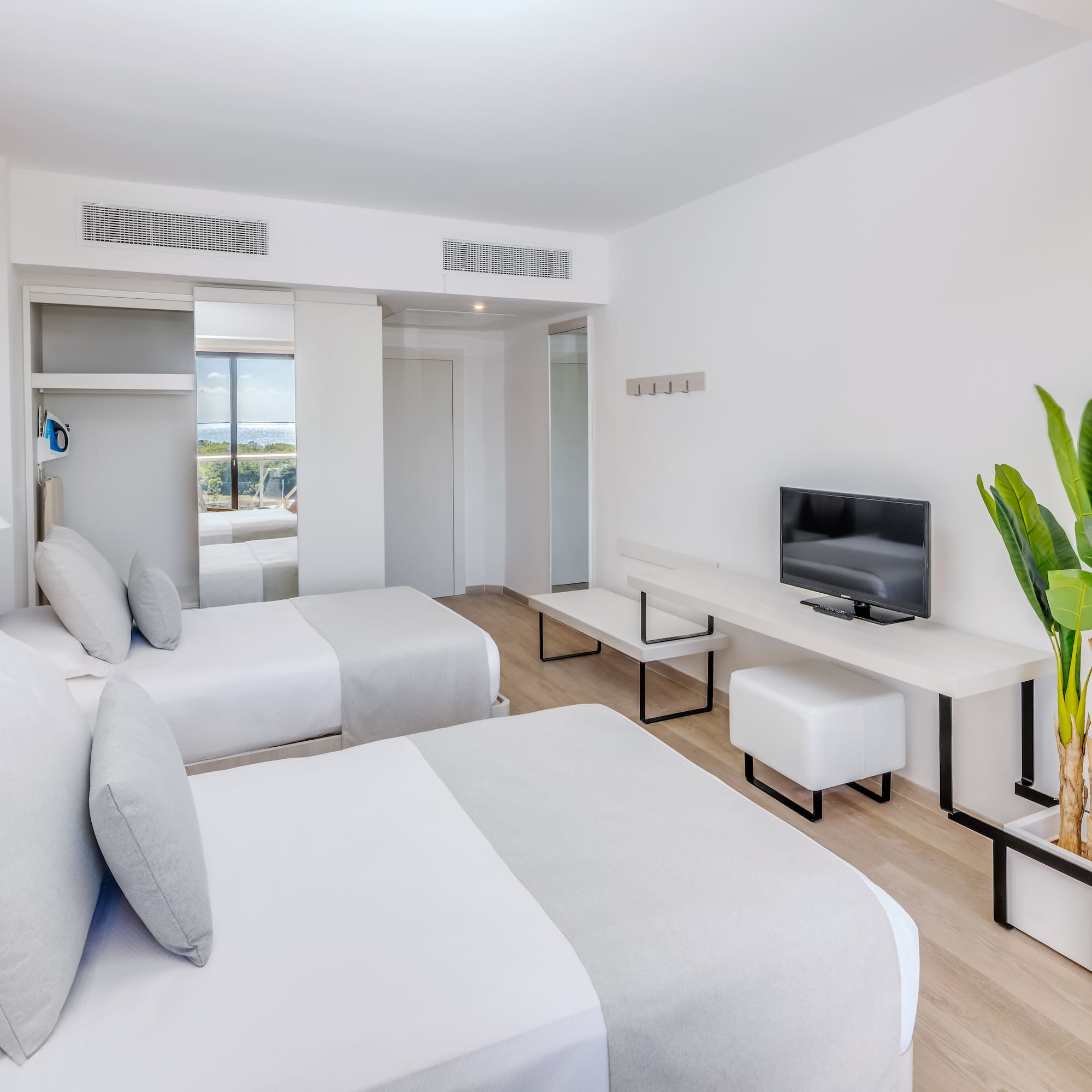 a room with two beds and a tv