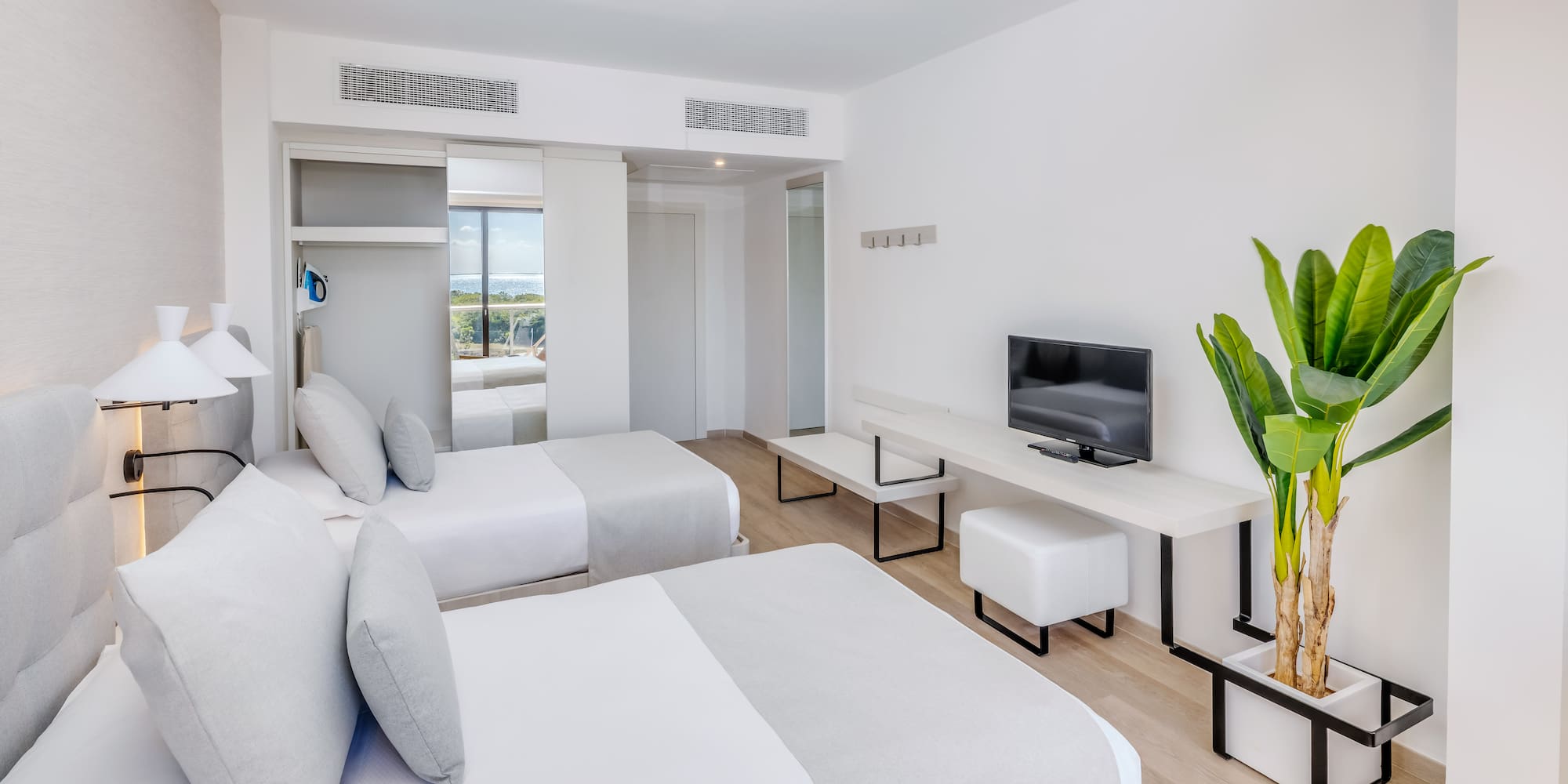 a room with two beds and a tv