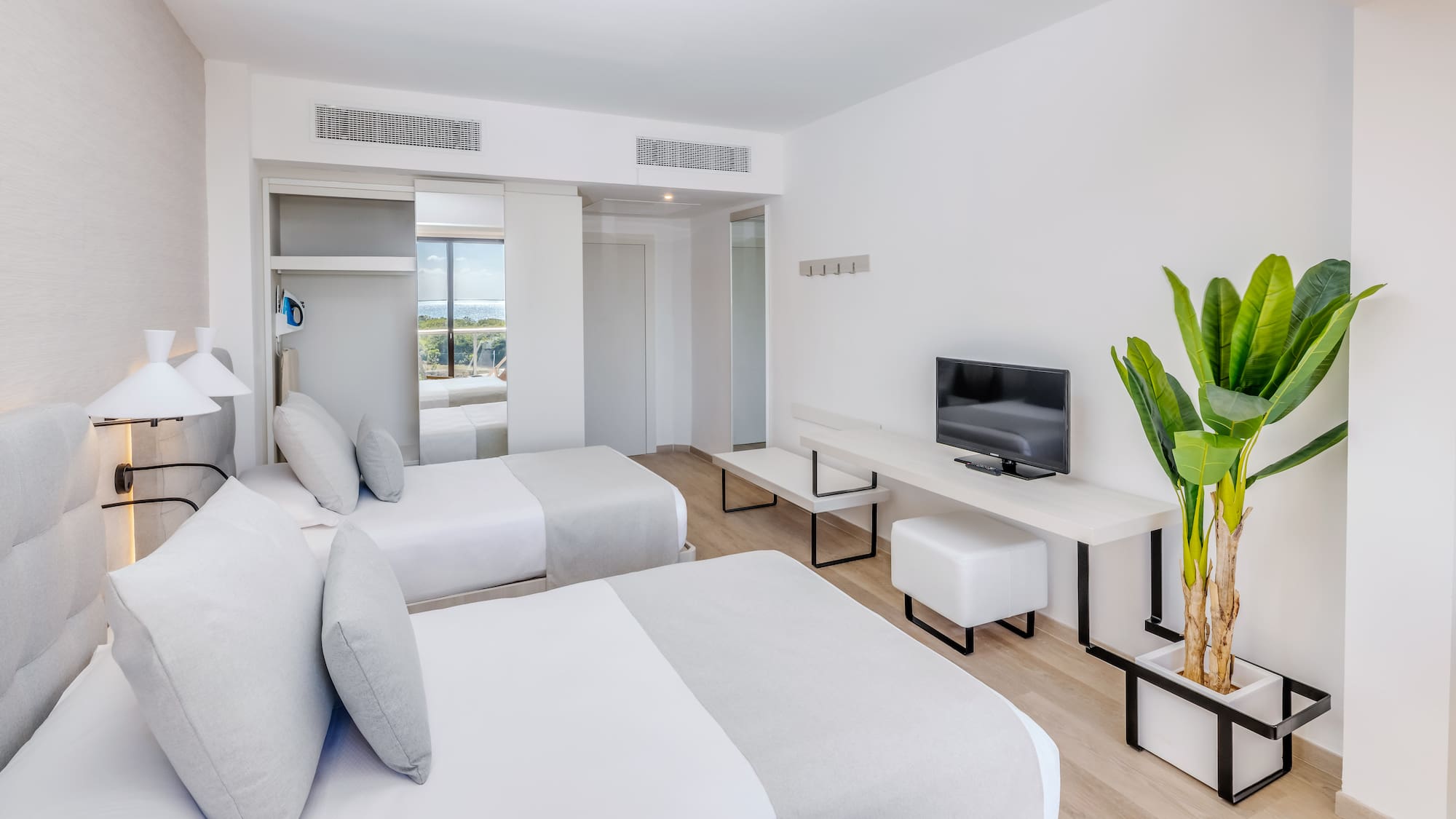 a room with two beds and a tv