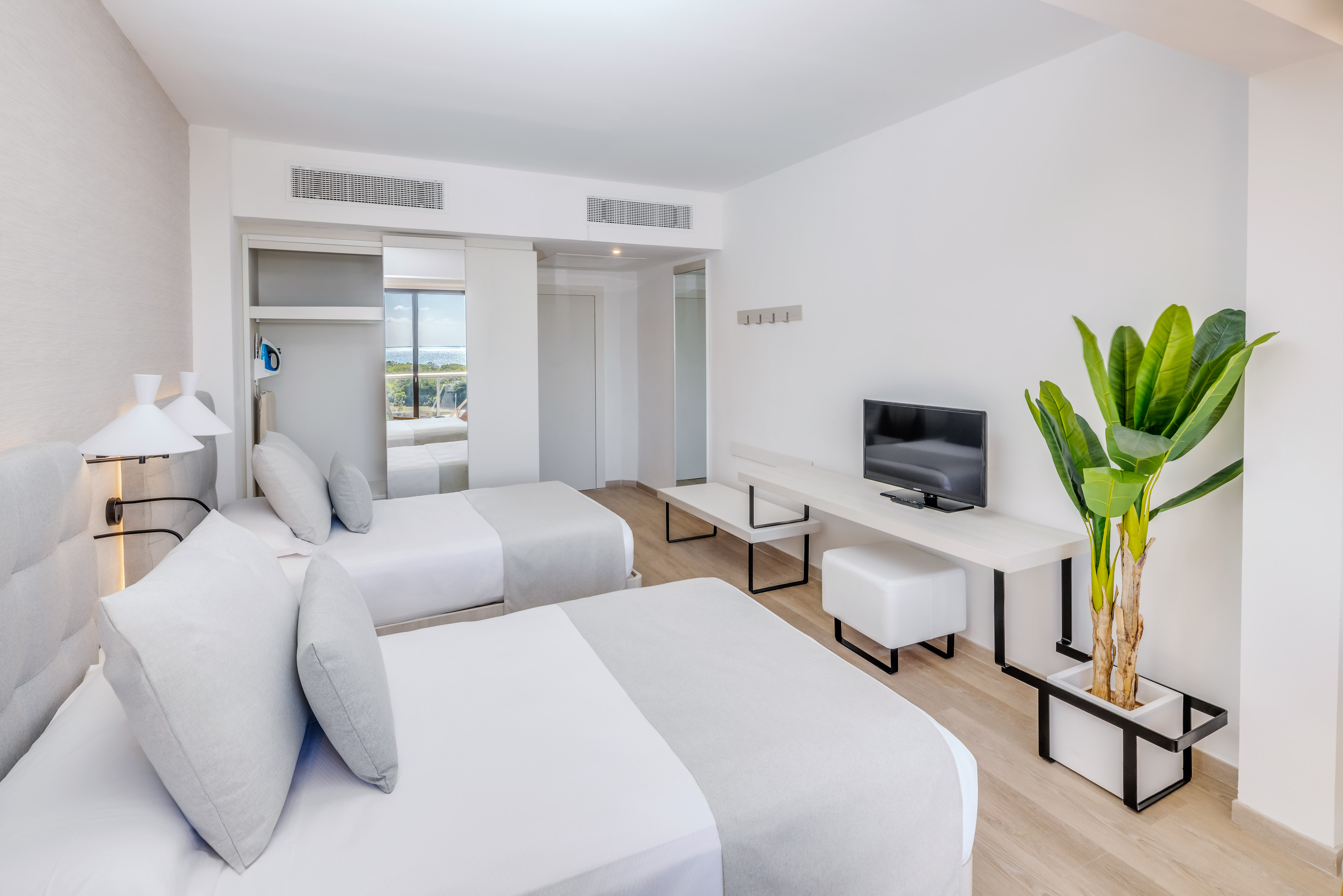 a room with two beds and a tv