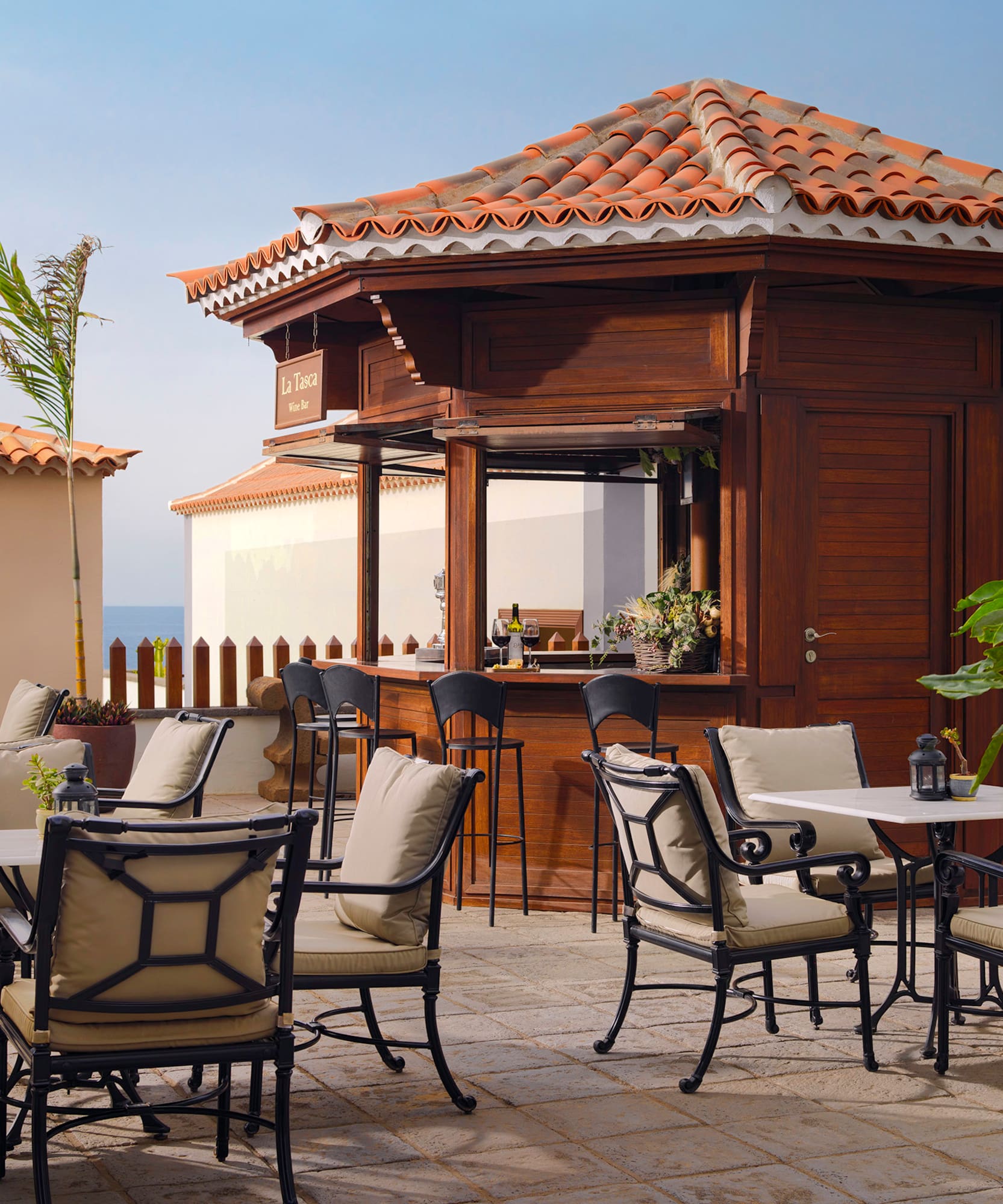 a patio with chairs and tables