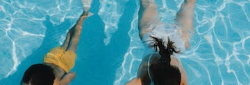 a woman swimming in a pool