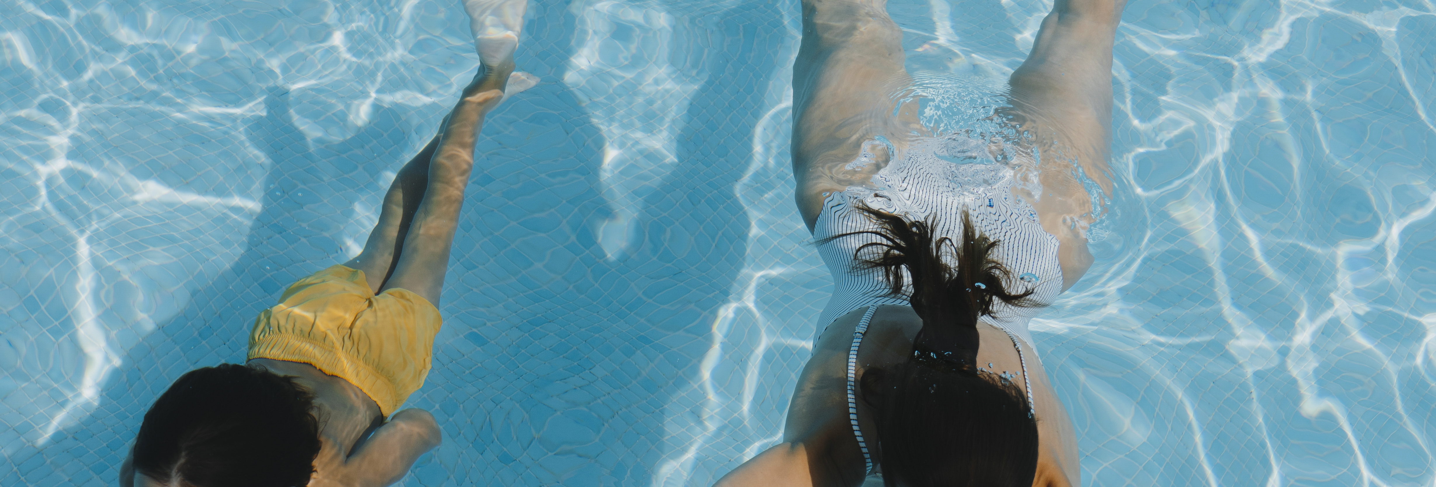 a woman swimming in a pool