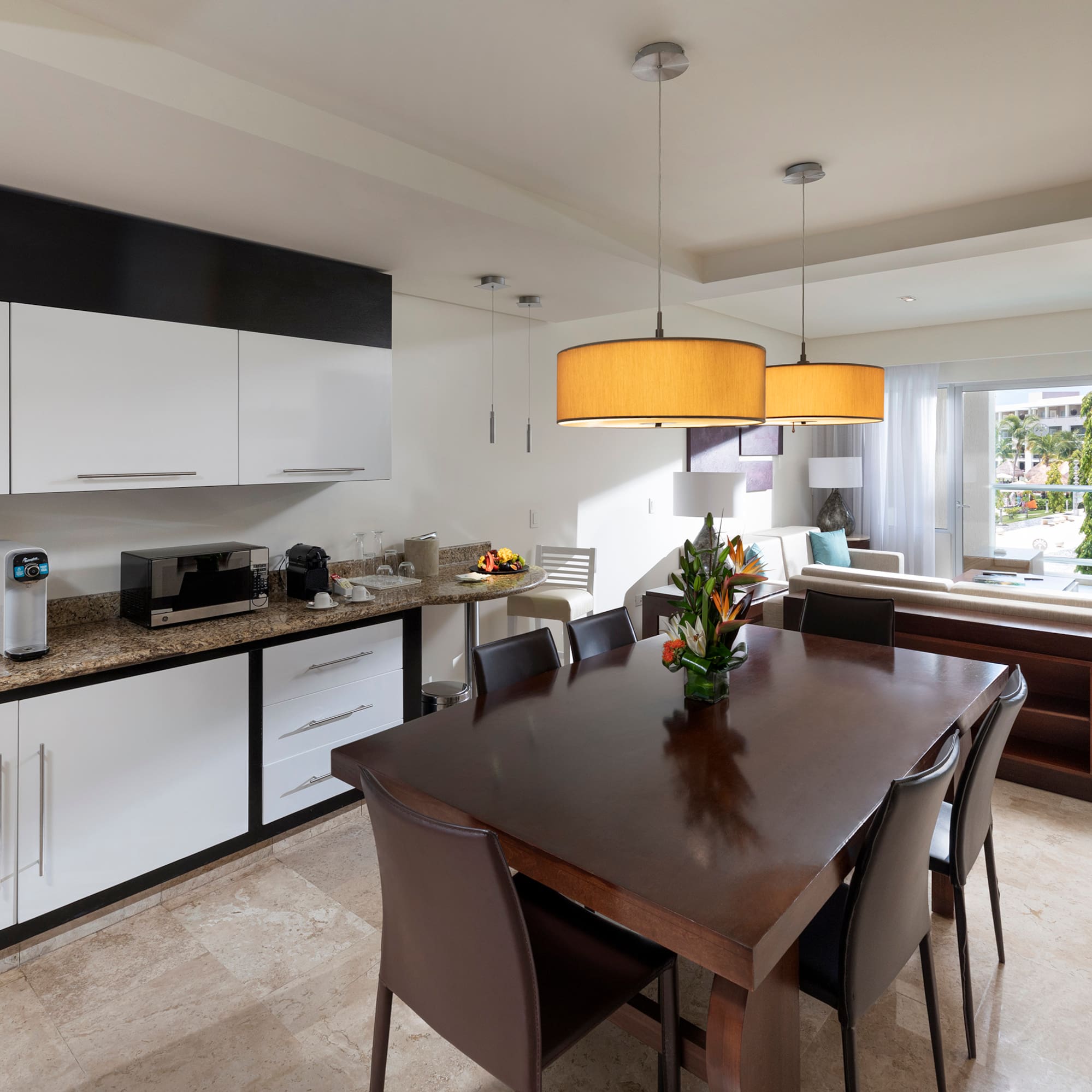 a kitchen with a table and chairs