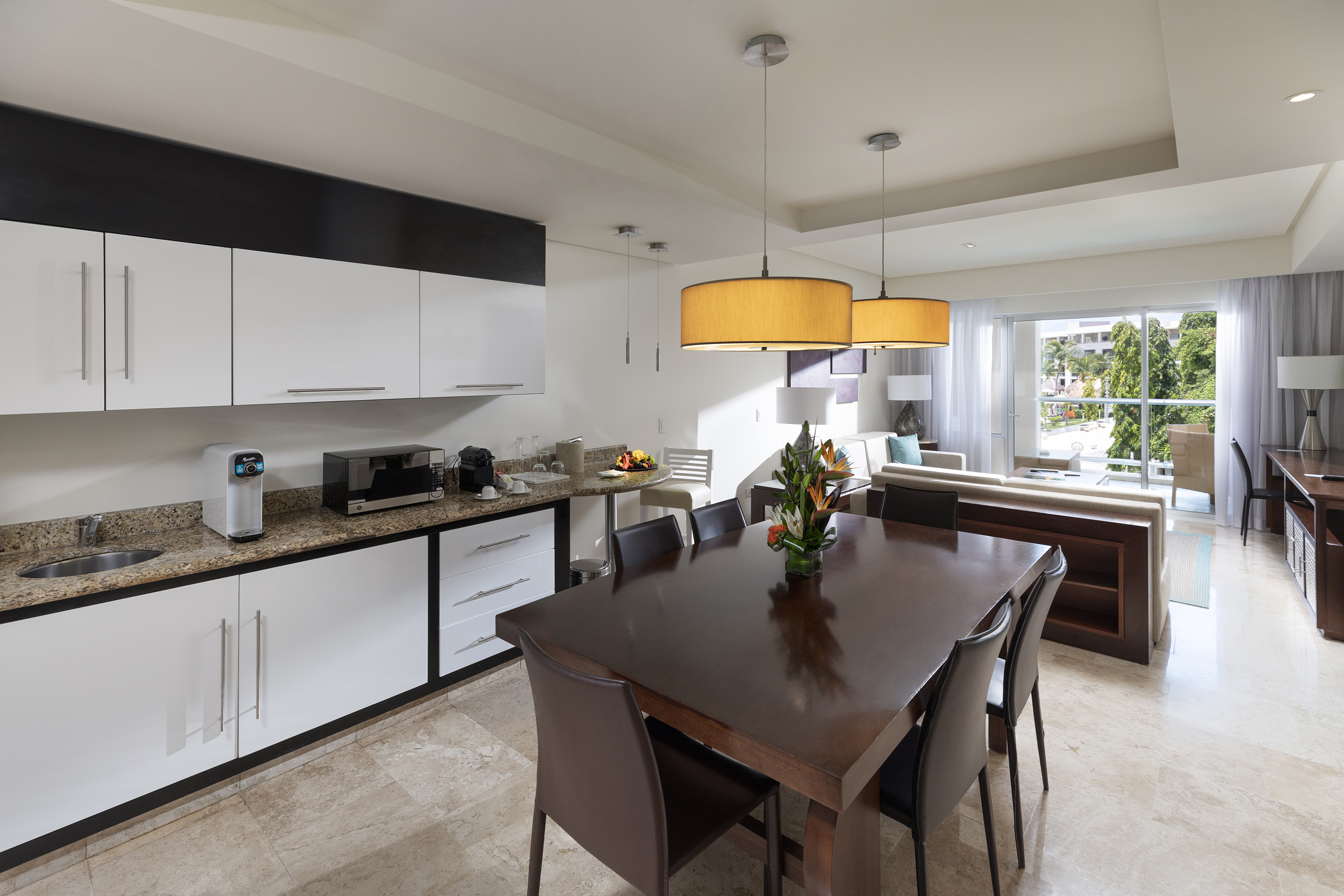 Modern open-concept apartment with kitchen, dining area, and living room.