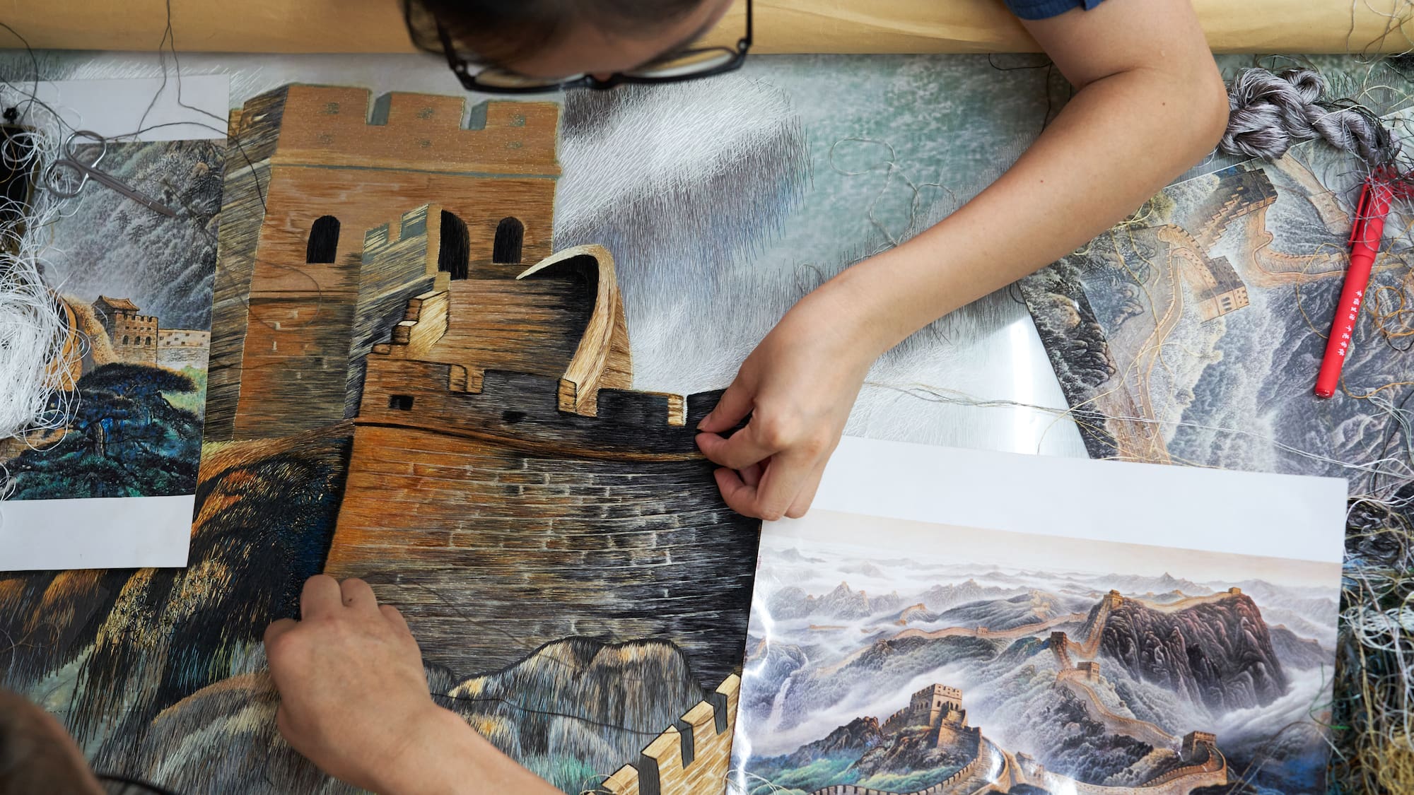 a person holding a piece of art