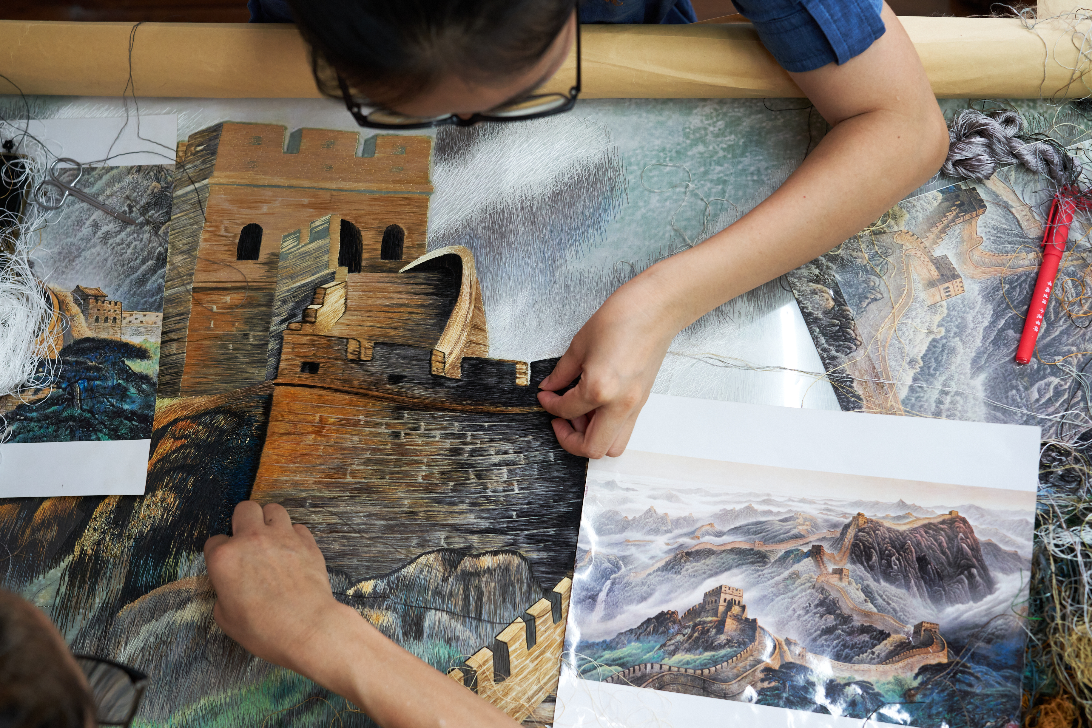 a person holding a piece of art