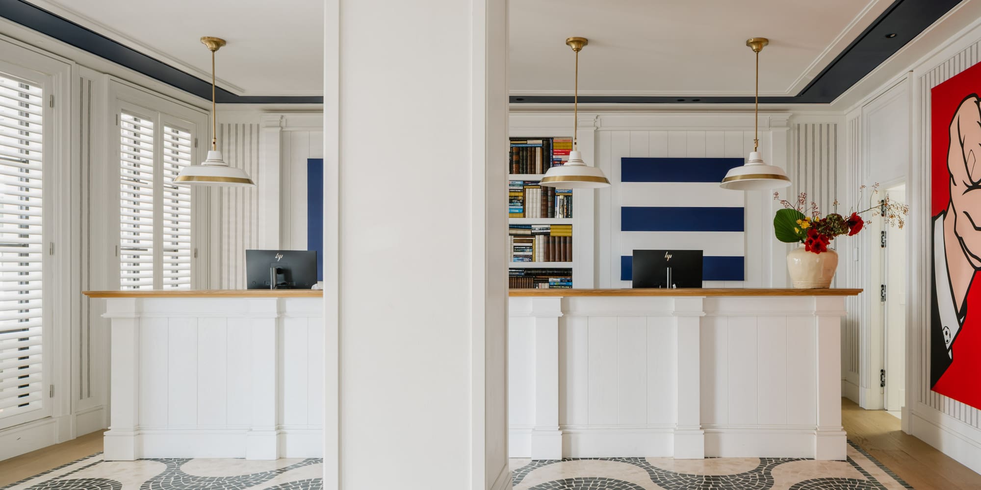 a white and black patterned floor with a white column and a white counter