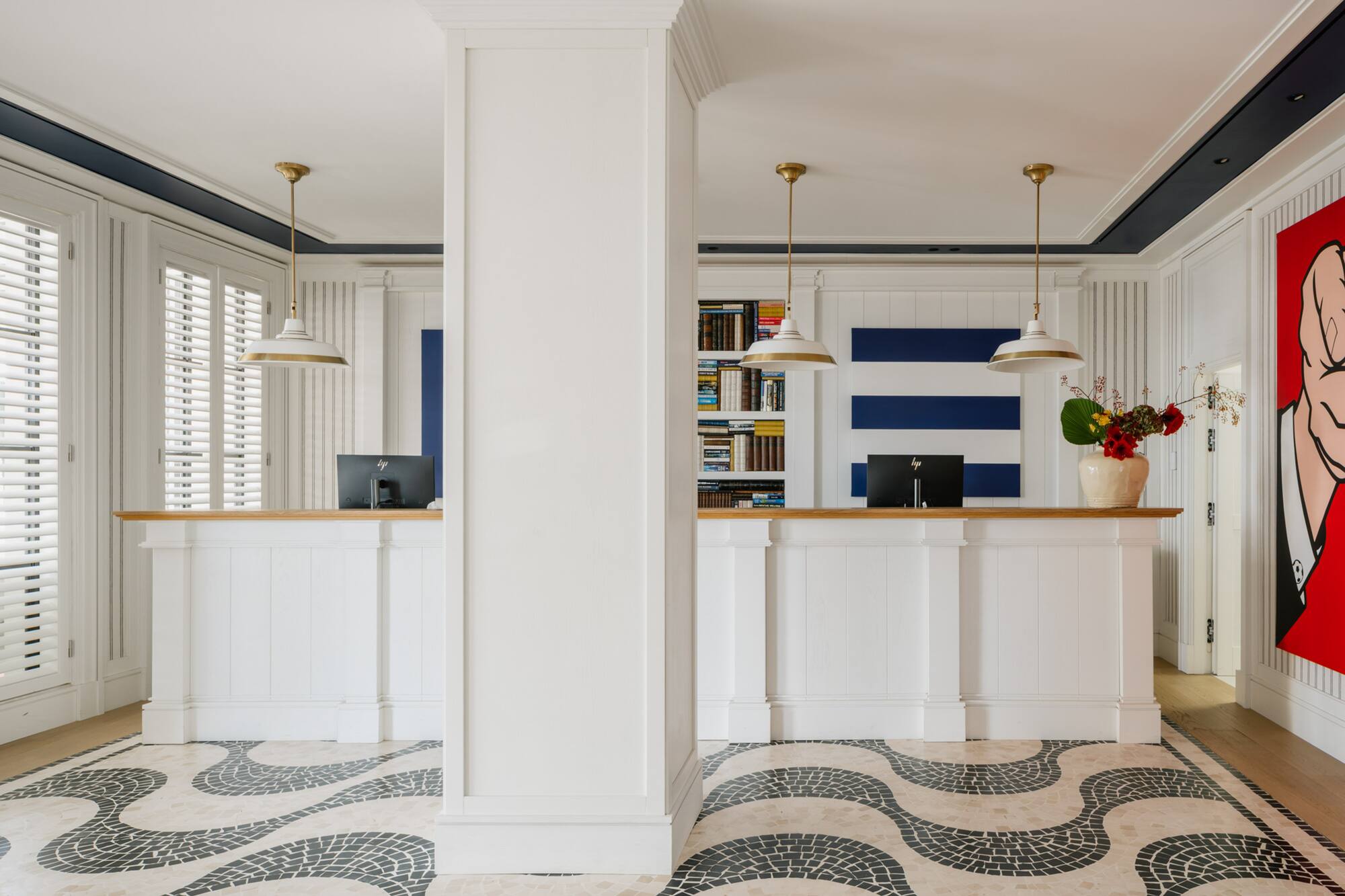 White and blue nautical hotel reception with mosaic wave floor.