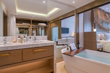 a bathroom with a tub and a mirror