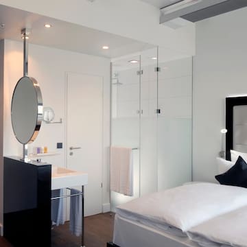 a bedroom with a mirror and a bed