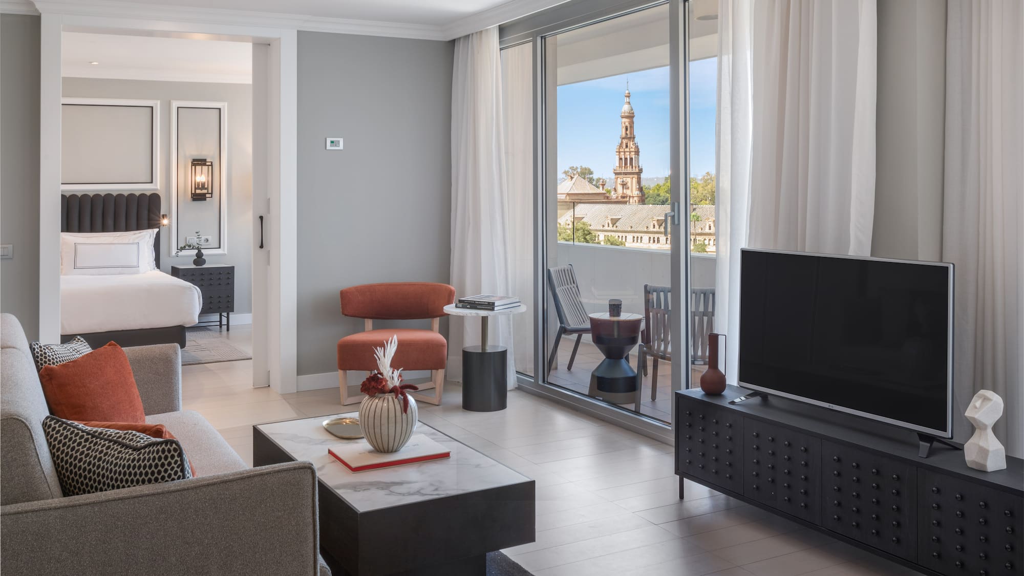 a living room with a television and a glass door