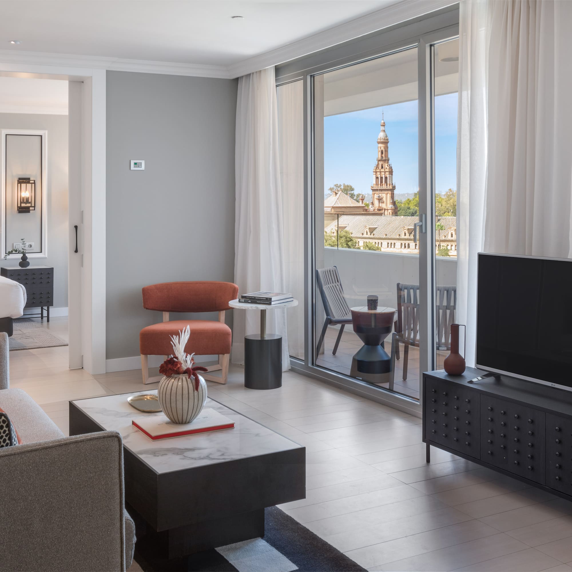 a living room with a television and a glass door