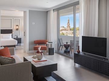 a living room with a television and a glass door