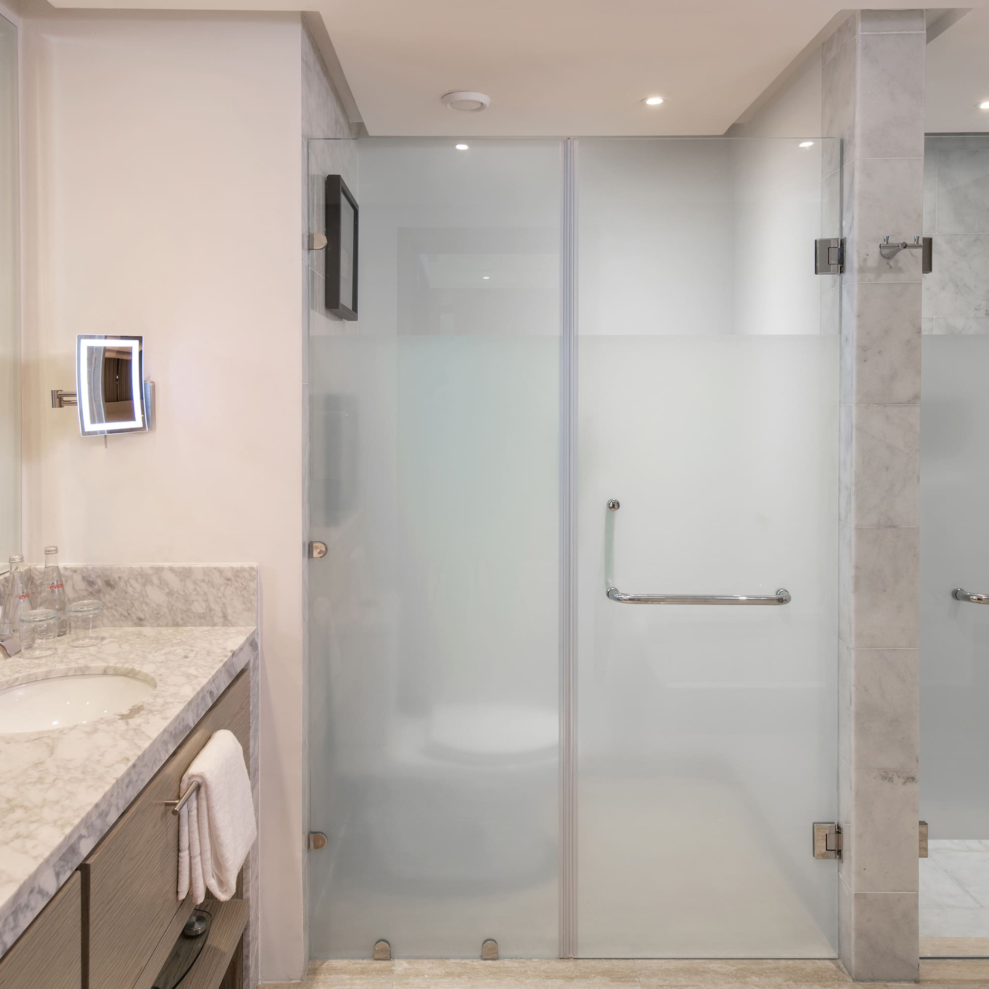 a bathroom with a glass shower door