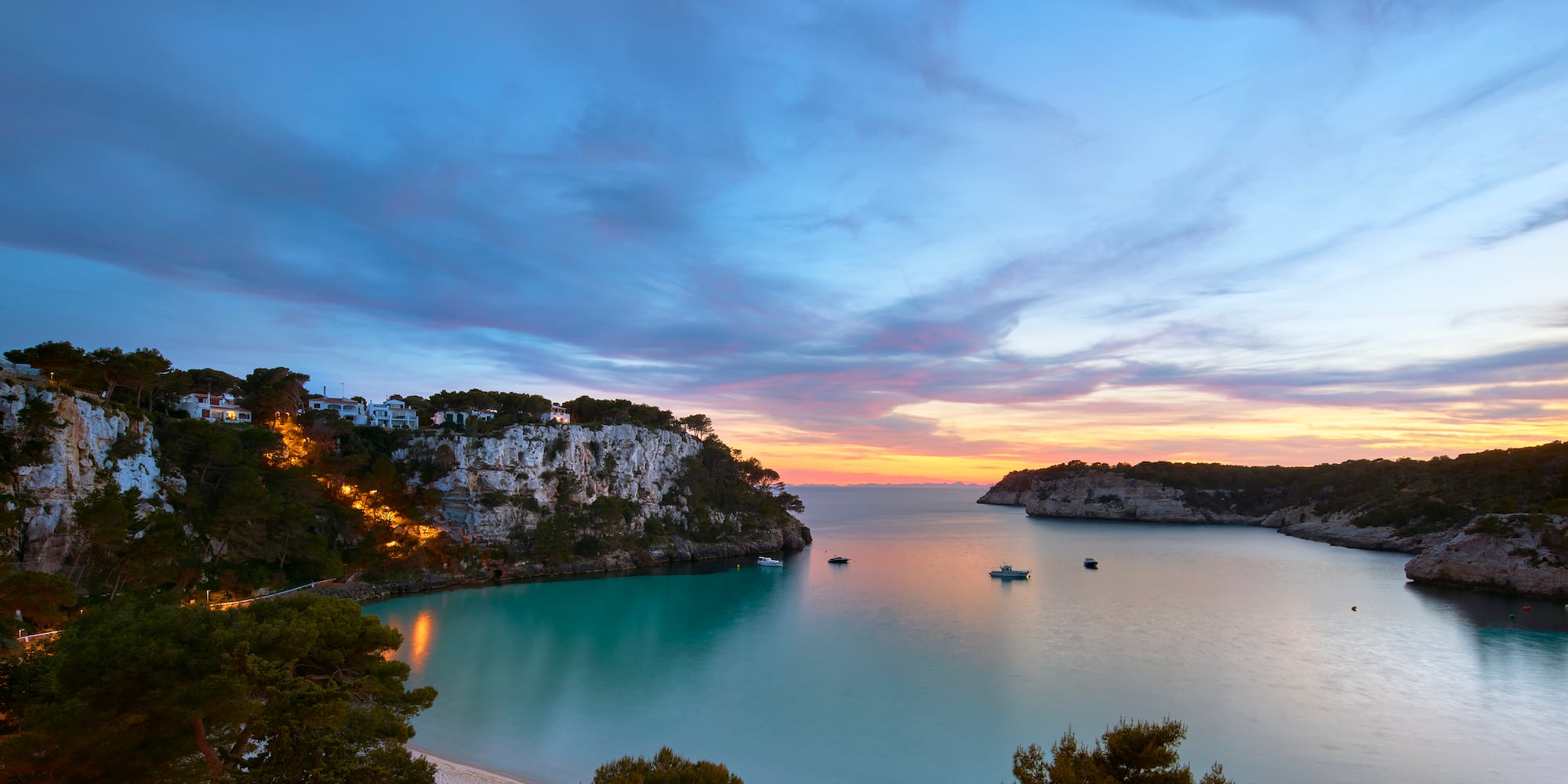 a body of water with boats and trees