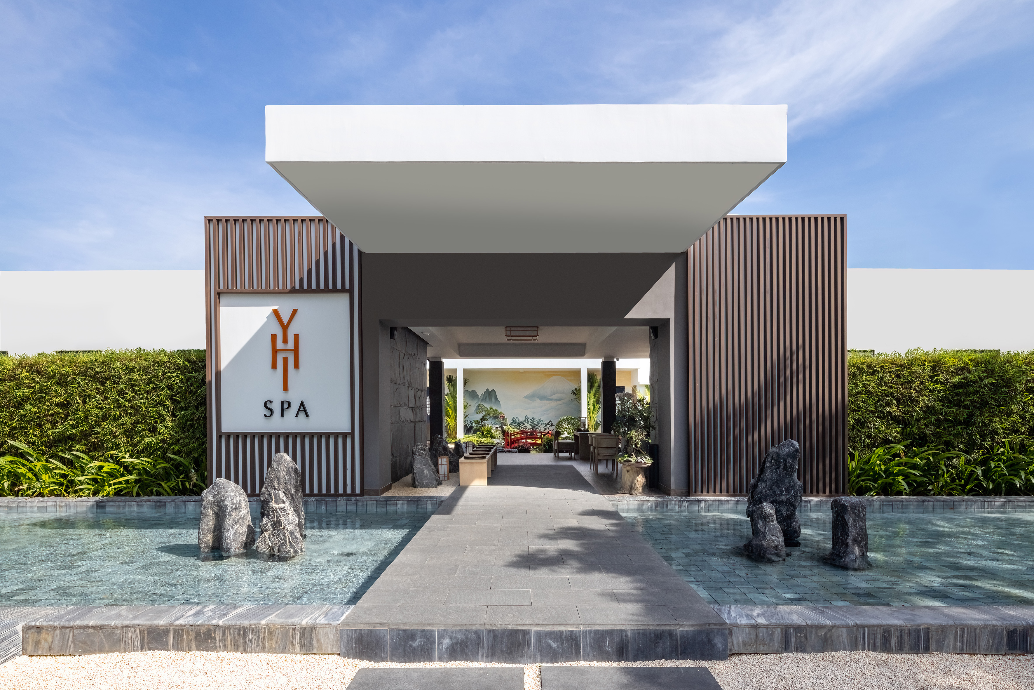 Modern YH SPA entrance, serene water features, and inviting pathway.