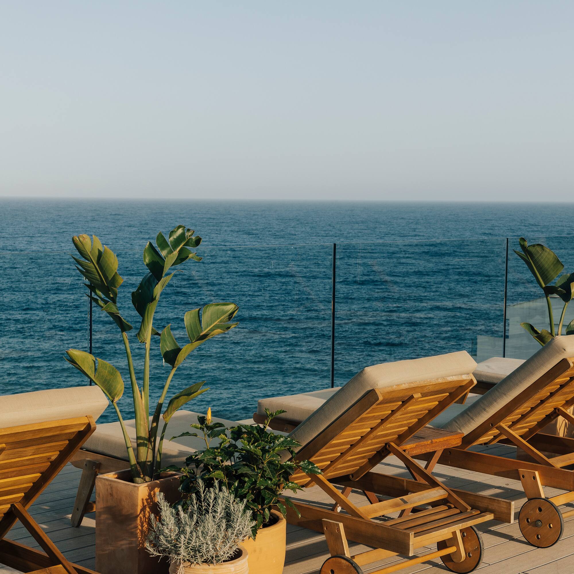 chairs on a deck overlooking the ocean