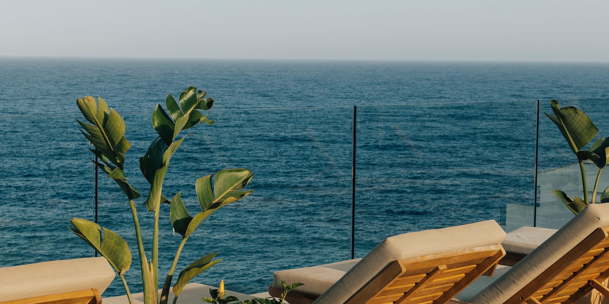 chairs on a deck overlooking the ocean