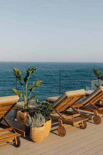 chairs on a deck overlooking the ocean