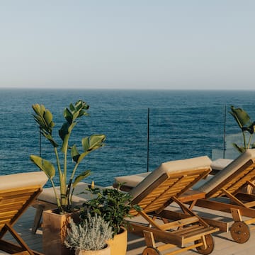 chairs on a deck overlooking the ocean