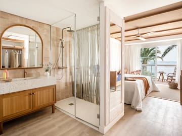 a bathroom with a shower and a bed