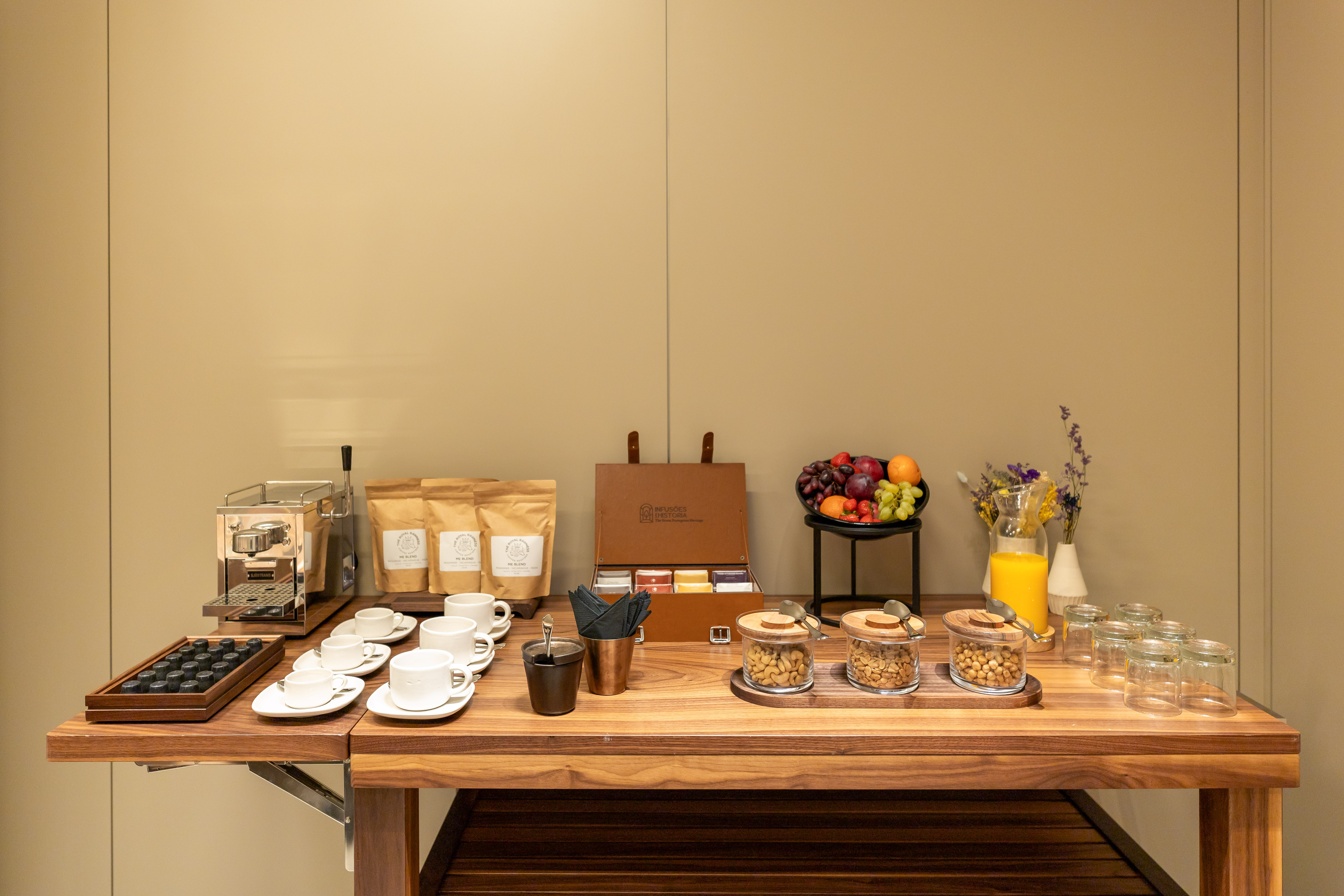 Hotel refreshment station: espresso, tea, fresh fruit, juice, nuts.