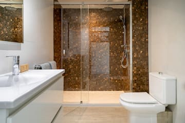 a bathroom with a glass shower door and sink