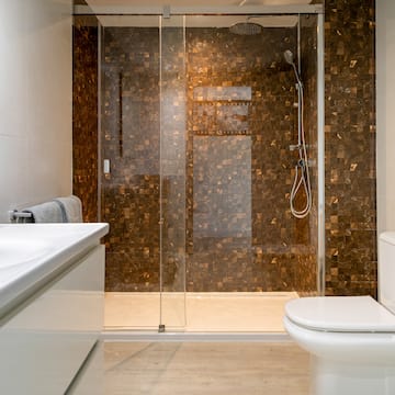 a bathroom with a glass shower door and sink