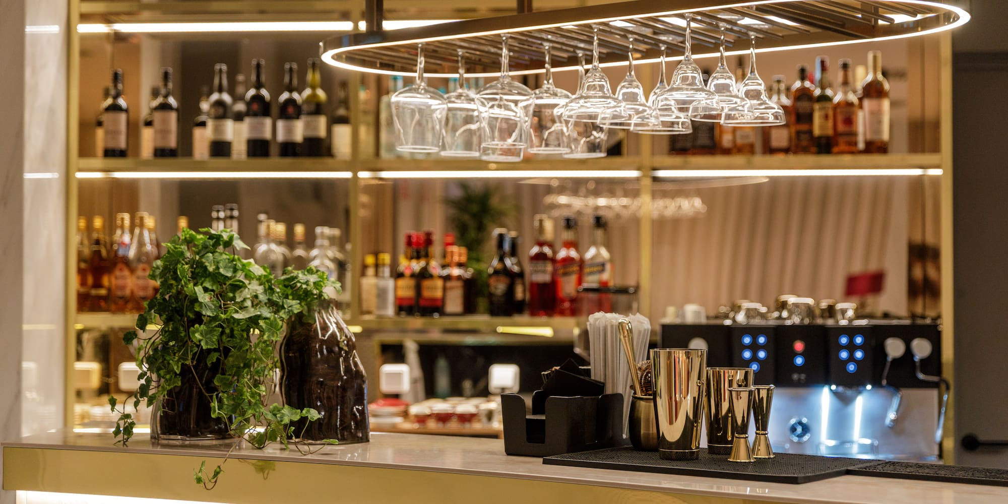 a bar with wine glasses over it