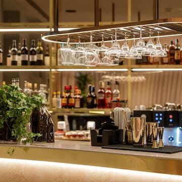 a bar with wine glasses over it