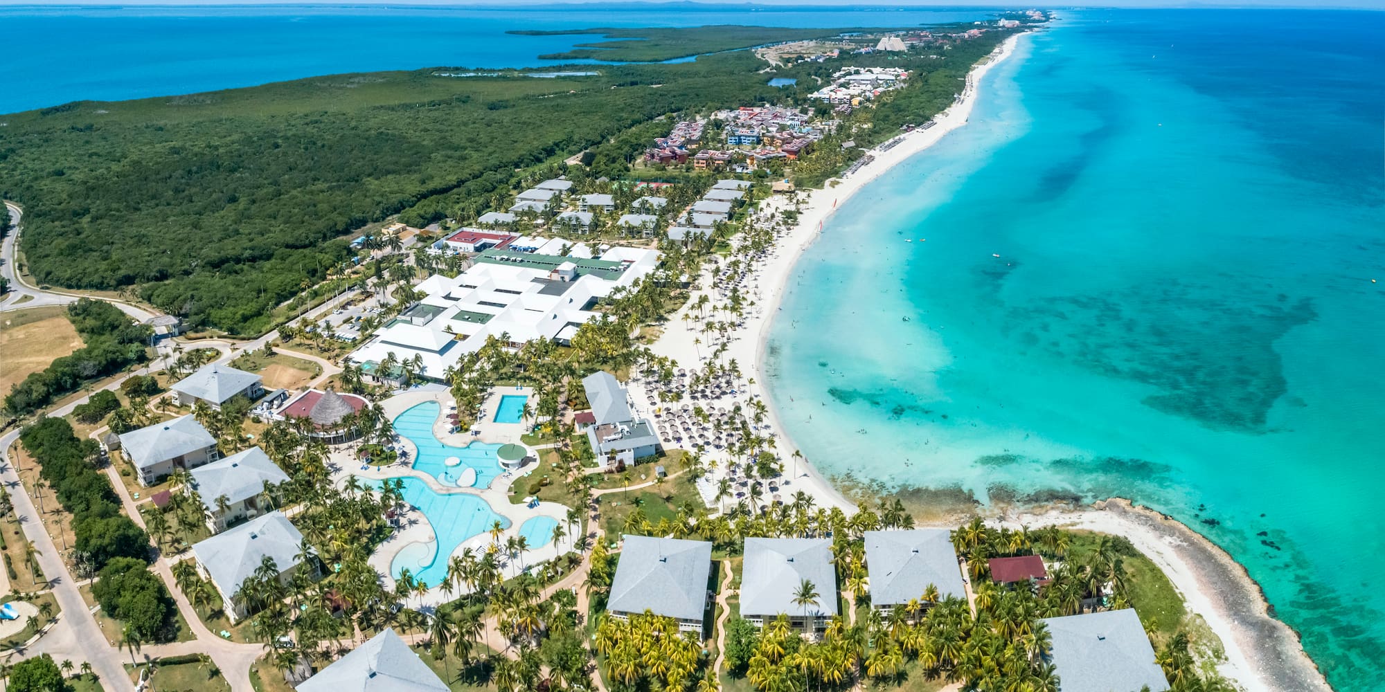 a beach with buildings and a body of water