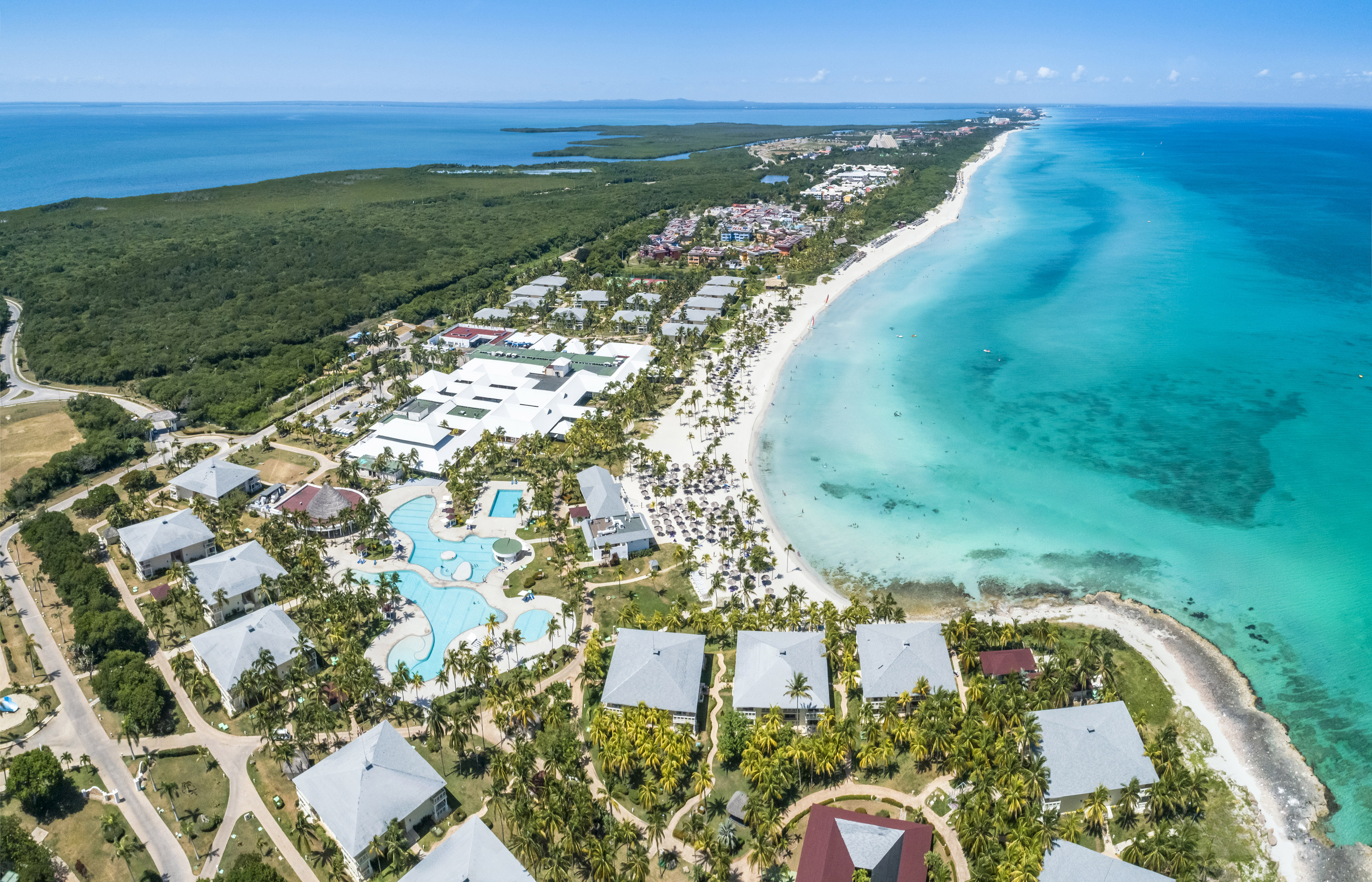 a beach with buildings and a body of water