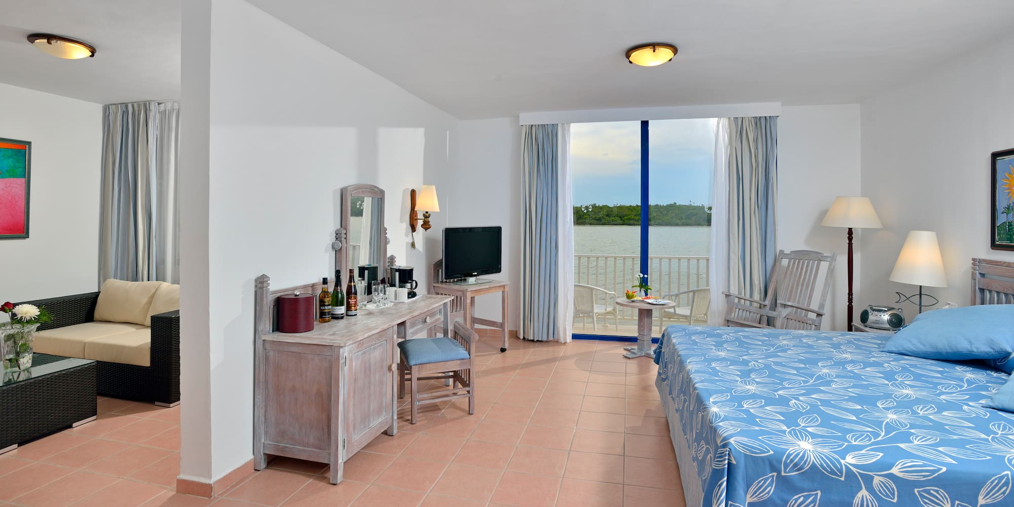 a room with a bed and a table and chairs