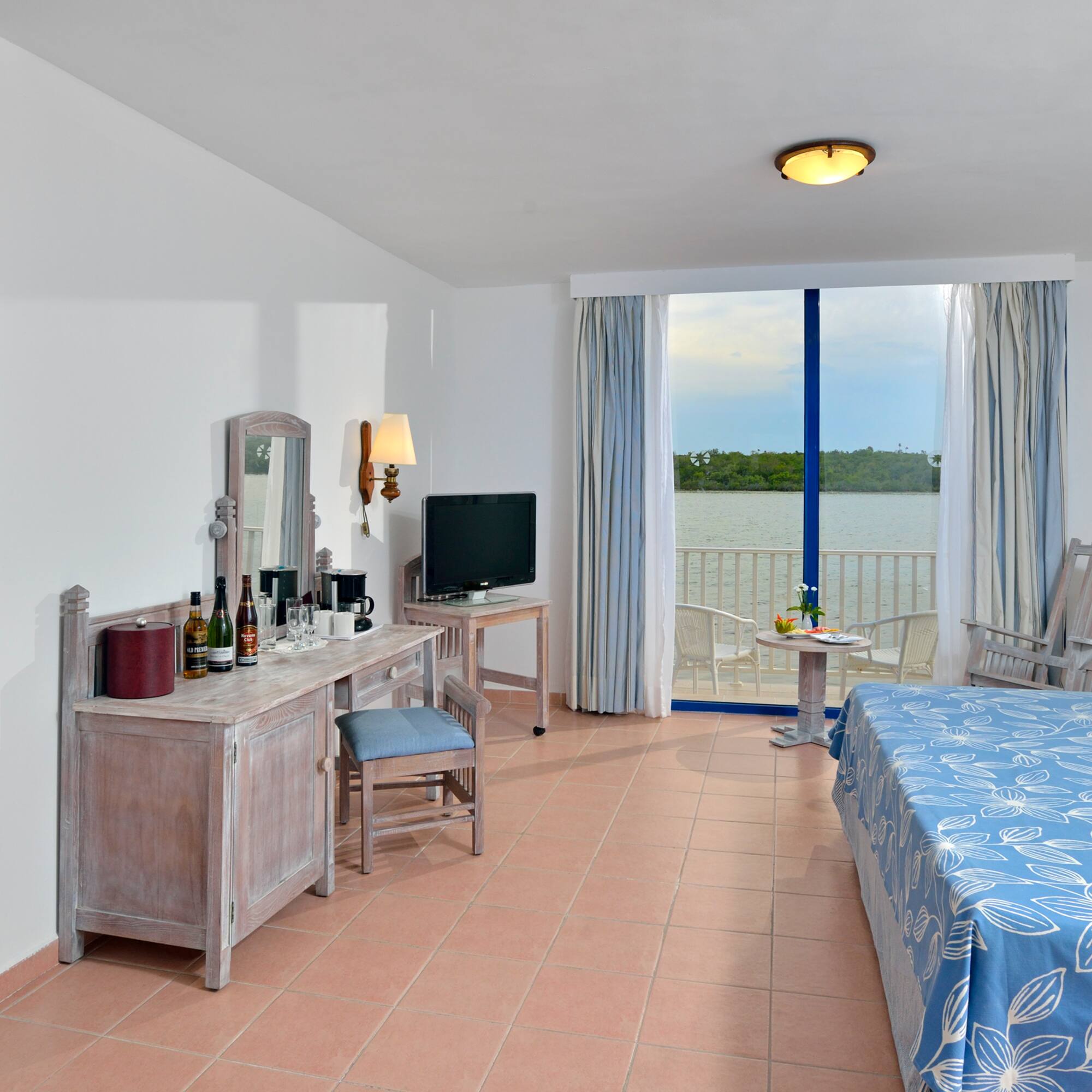 a room with a bed and a table and chairs