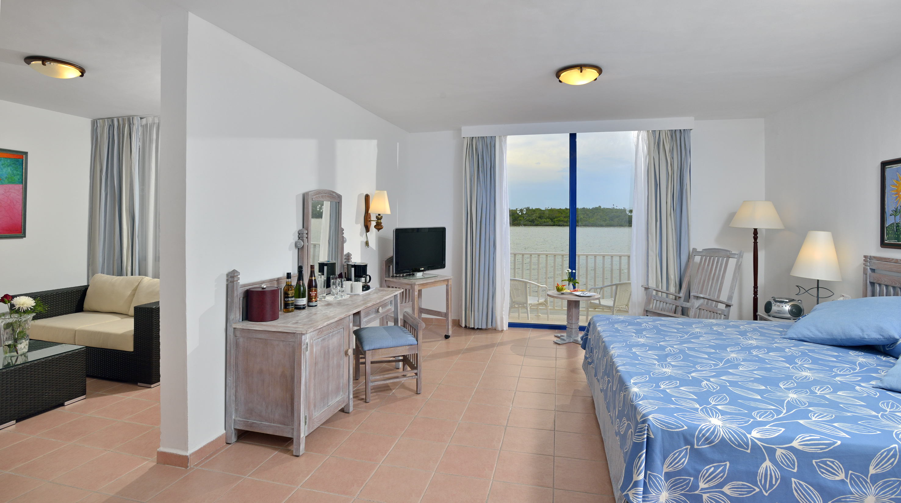 a room with a bed and a table and chairs