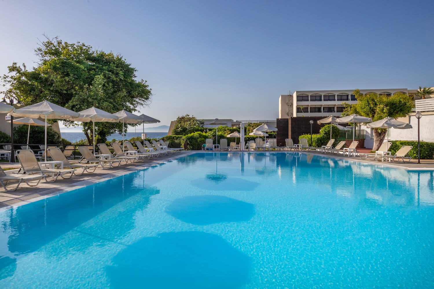 a swimming pool with umbrellas and chairs