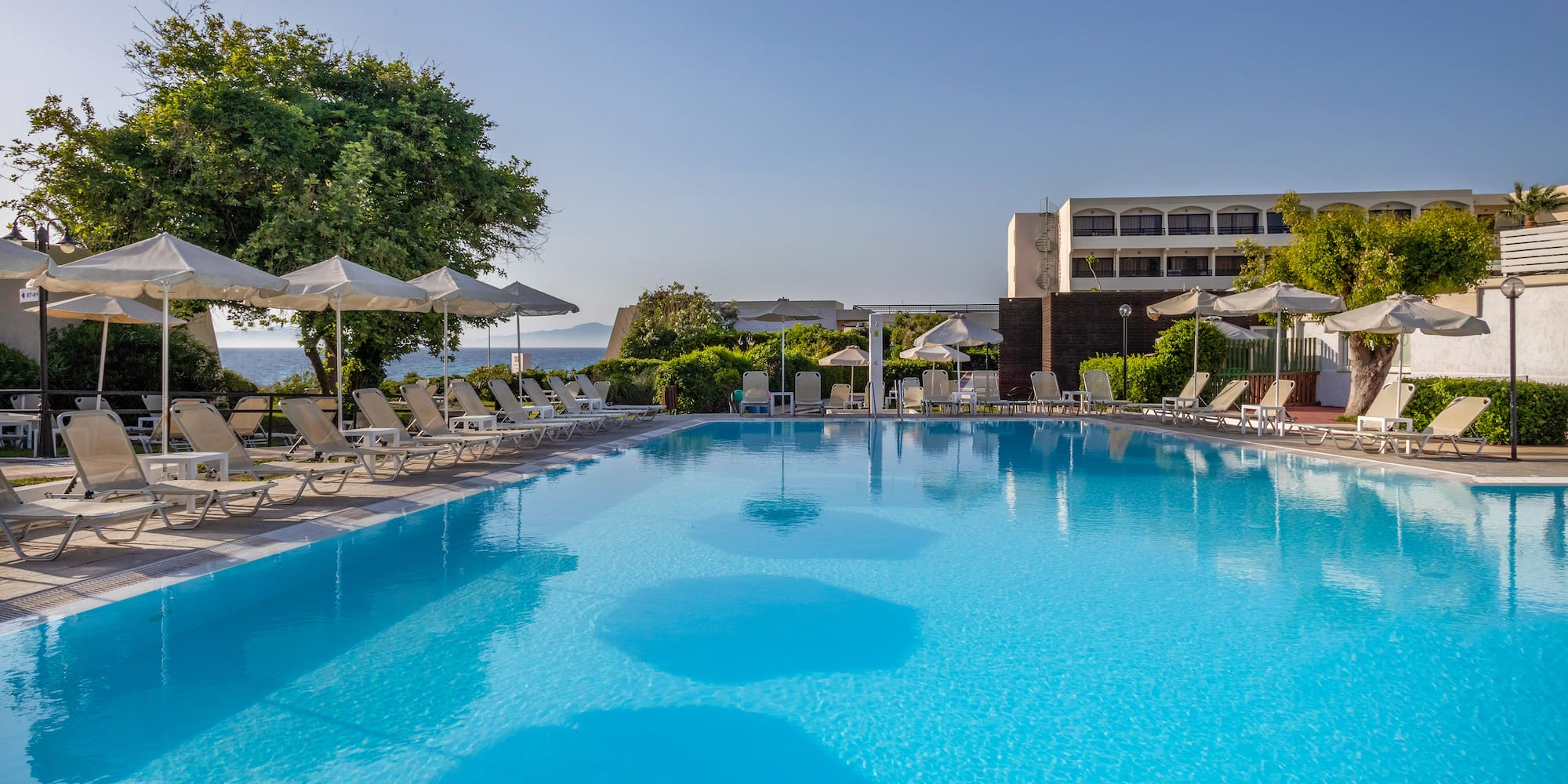 a swimming pool with umbrellas and chairs