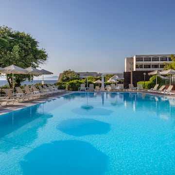 a swimming pool with umbrellas and chairs