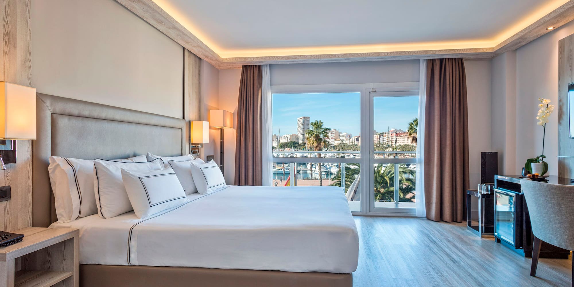 a bedroom with a large bed and a television