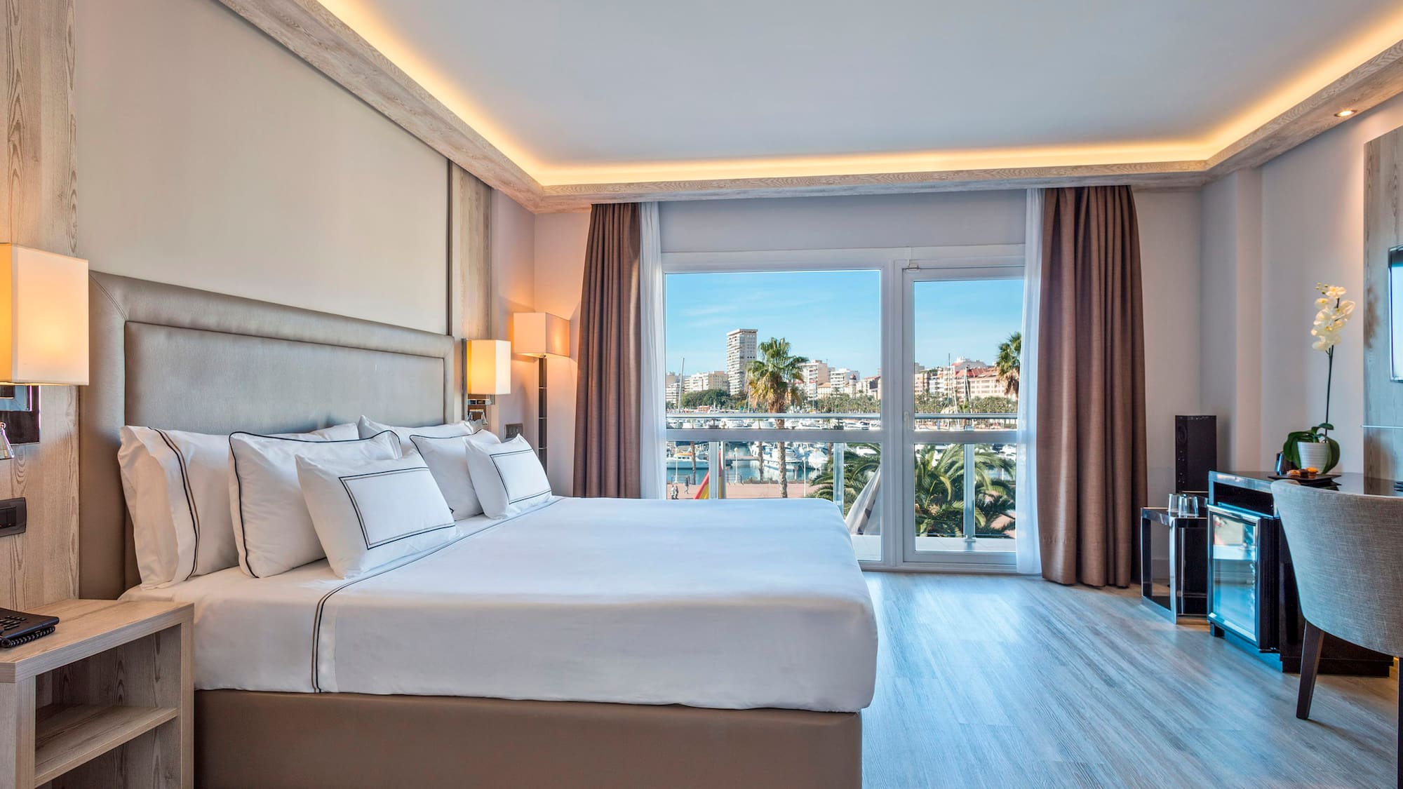 a bedroom with a large bed and a television