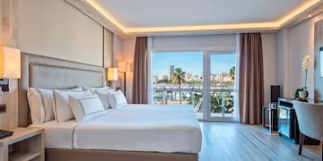 a bedroom with a large bed and a television