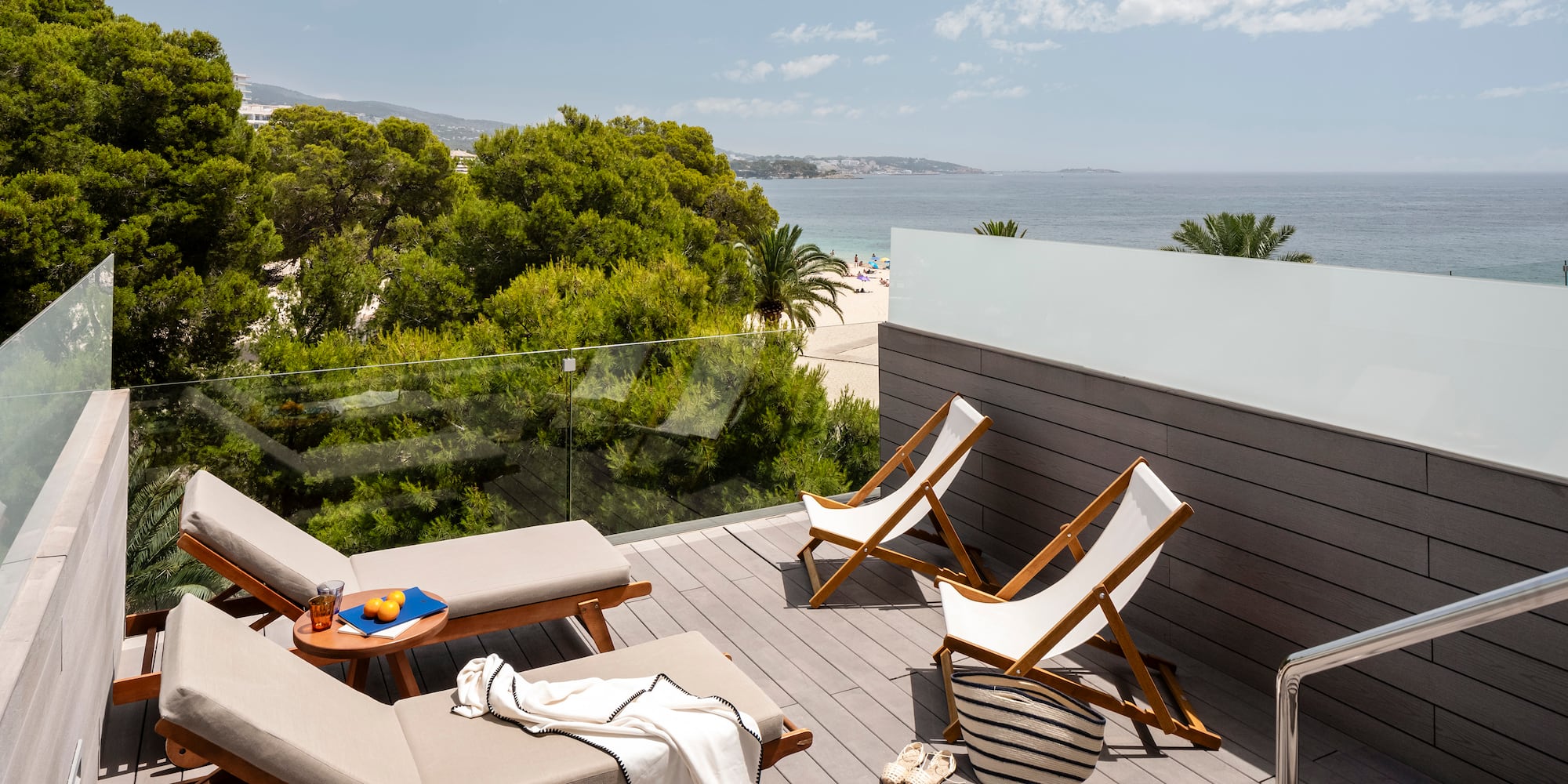 a deck with chairs and beach view