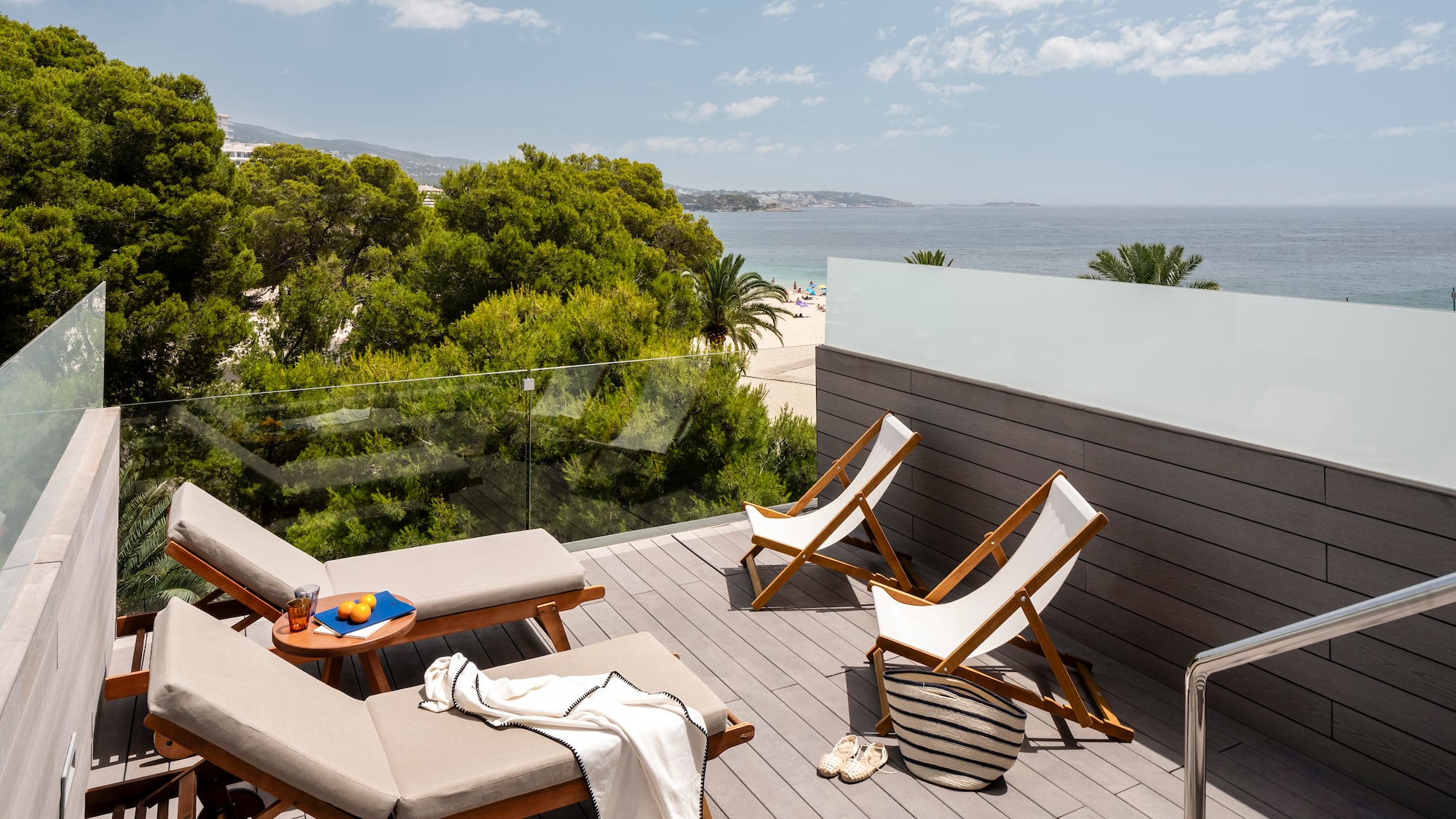 a deck with chairs and beach view