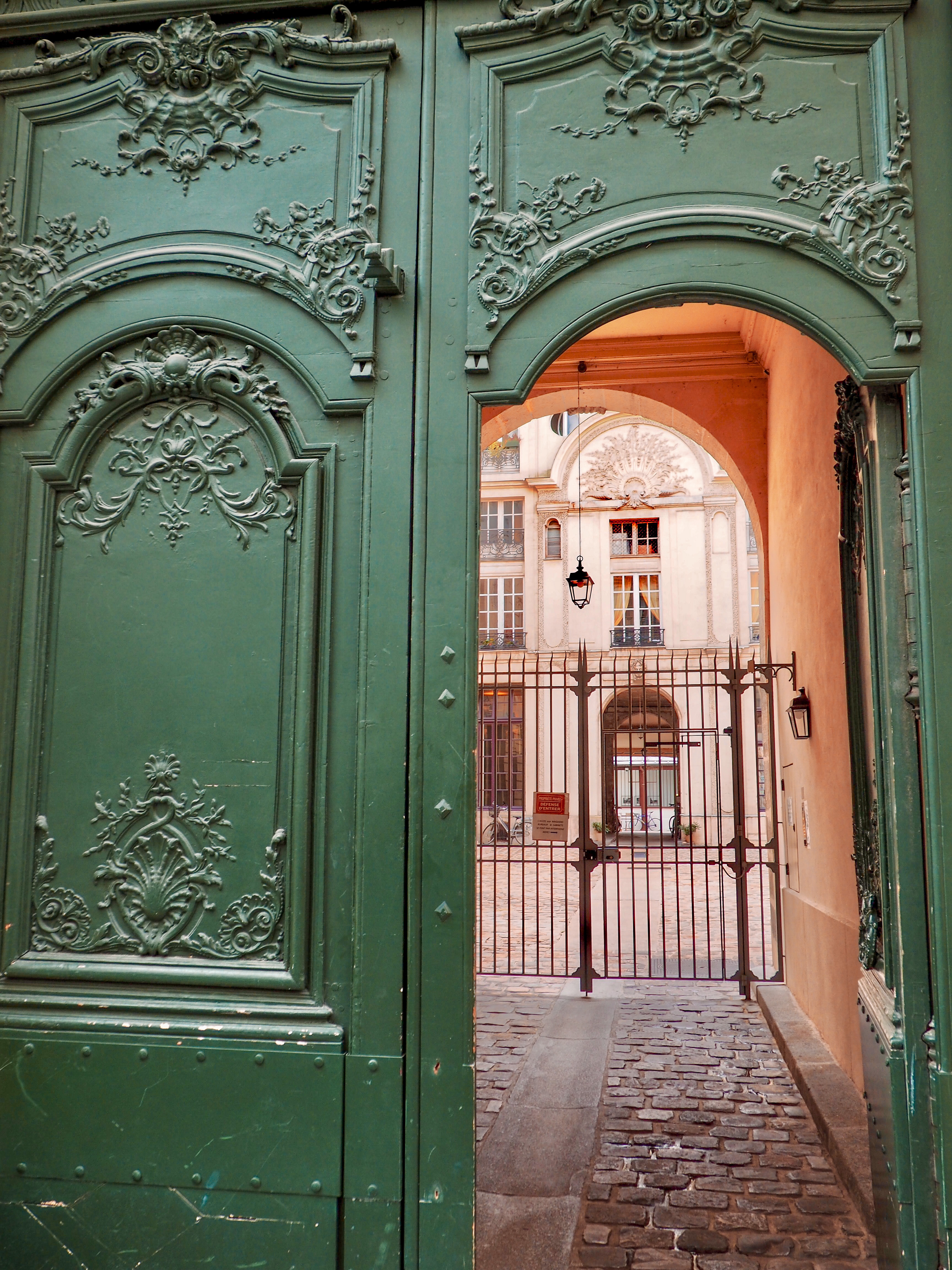 a green gate with a door open
