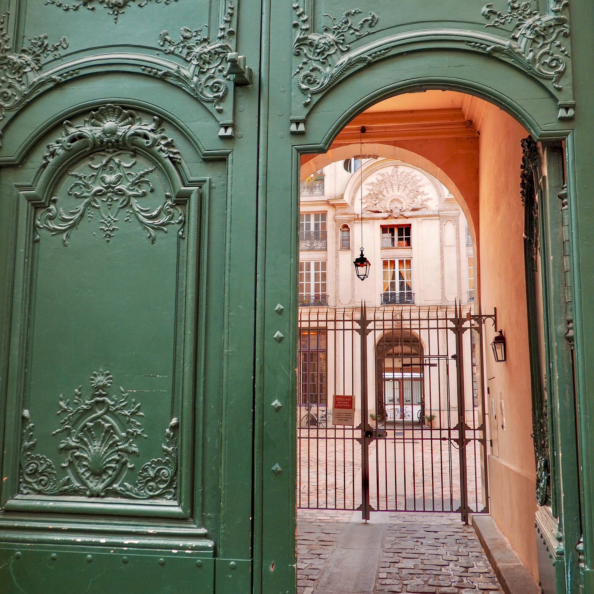 a green gate with a door open